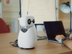 DIY Robots: Reachy Mini is Leading This Revolution Photo of a Hugging Face Reachy Mini robot on a desk.