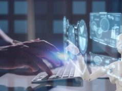 Google rolls out AI coding device for GitHub repos Developer at a physical keyboard with generative AI coding assistance in virtual overlays.