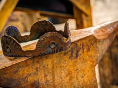 Rust 1.90 brings workspace publishing assist to Cargo A rusty crown sits on an anvil.