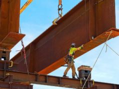 Python has a pal in Rust Rusty steel girder and two meter web installed on a bridge abutment and scaffolding as part of a new freeway interchange. Building construction infrastructure project.