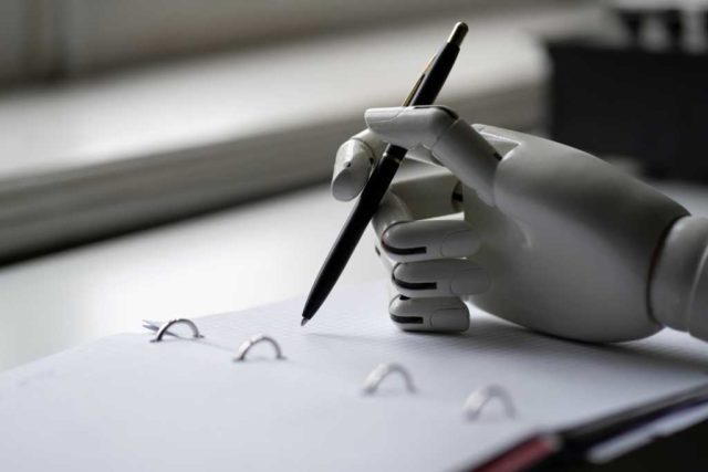 The-rebellion-against-robot-drivel.jpg artificial robotic arm write down some notes with pen