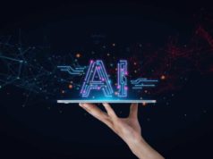 Before you construct your first enterprise AI app A human hand against a midnight-black background holds a tablet like a platter with the word "AI" resting on top. AI tools, AI technology, AI innovation.