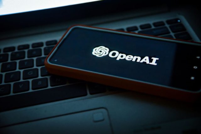 The-Biggest-AI-Moments-of-2025-Surveillance-Layoffs-and-R.jpg OpenAI app on smartphone.