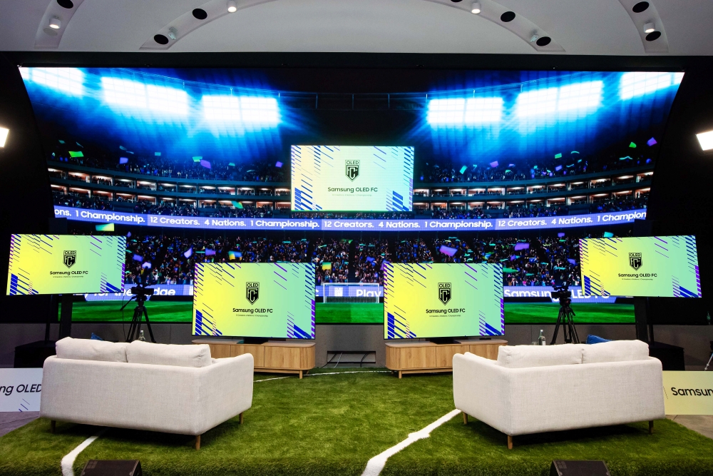 The main stage at Samsung KX is set for competition, showcasing EA SPORTS FC™ 26 gameplay on Samsung OLED TVs during Samsung OLED FC.