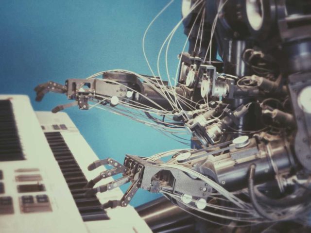 Kotlin-2.3.20-harmonizes-with-C-JavaScriptTypescript.jpg robot playing piano