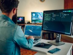 21 LLMs tuned for particular domains Back view of a senior developer typing code and programming a new generation of AI bots and AI generators at the home office. Artificial intelligence development and programming AI bots.