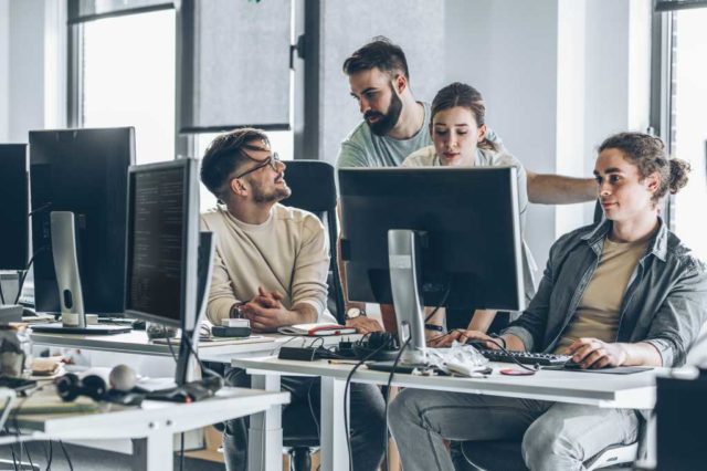Notion-courts-developers-with-a-platform-for-AI-agents-a.jpg Group of programmers and software developers working on a new project at the office.
