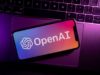 US tells OpenAI to limit entry to its strongest … Azores, Portugal - 21.01.2023: SmartPhone on top of laptop keyboard with OpenAI Logo on the screen.