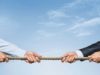 AI or conventional cloud providers? Tug war, two businessman pulling a rope in opposite directions isolated on white background