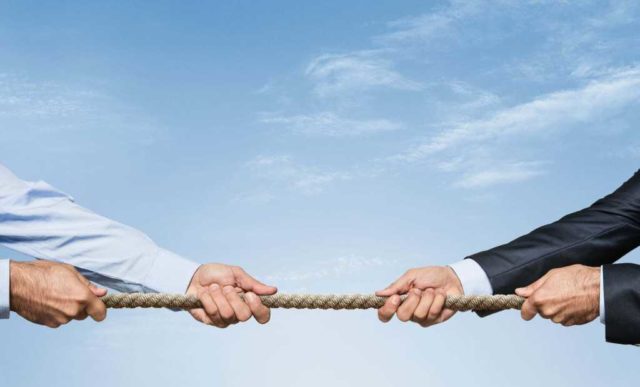 AI-or-traditional-cloud-services.jpg Tug war, two businessman pulling a rope in opposite directions isolated on white background