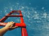 The strangest developer productiveness metric of all time Development Attainment Motivation Career Growth Concept. Mans Hand Reaching For Red Ladder Leading To A Blue Sky